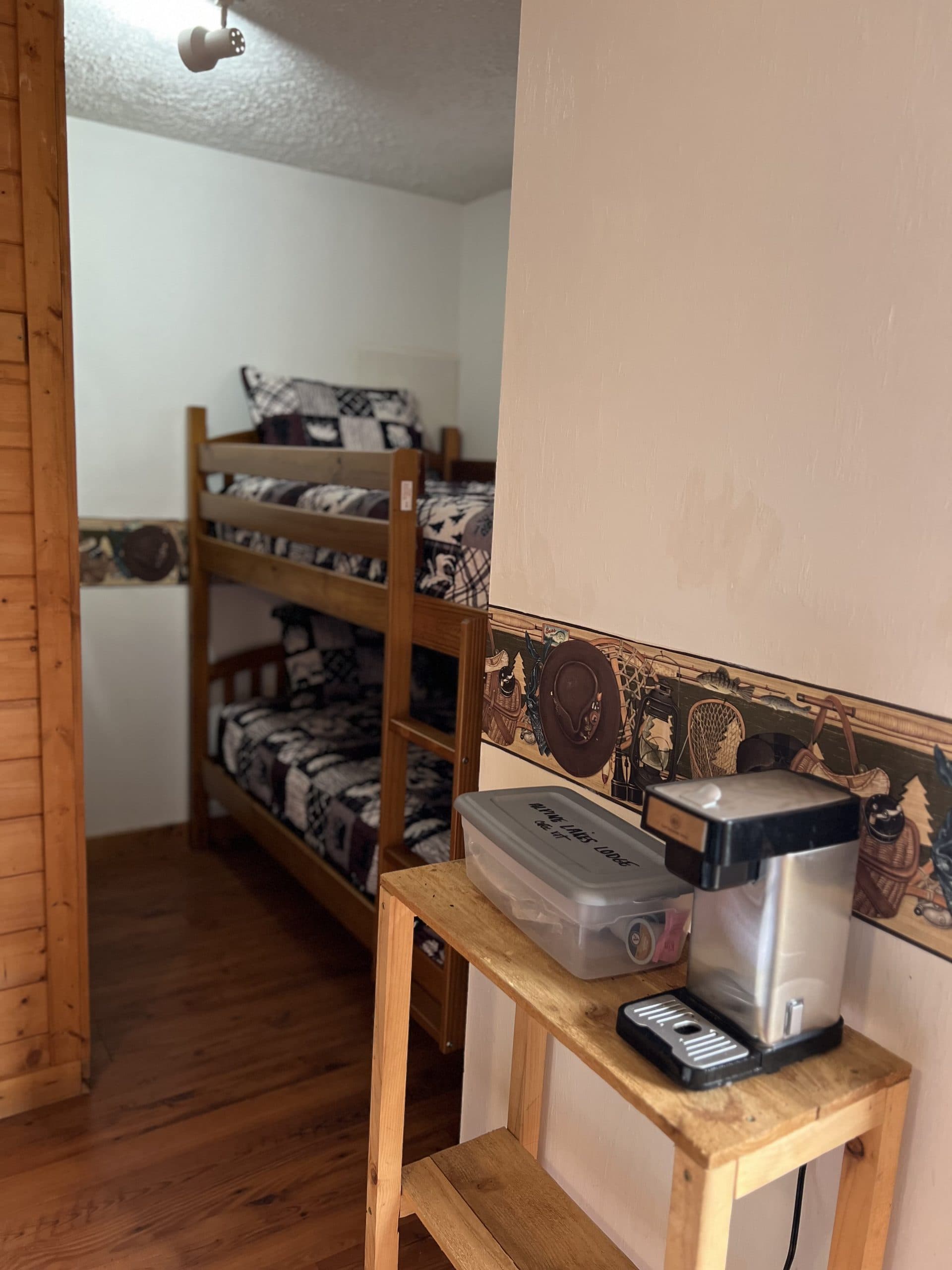 Cabin bunk beds with kitchenette showing coffee maker and air fryer