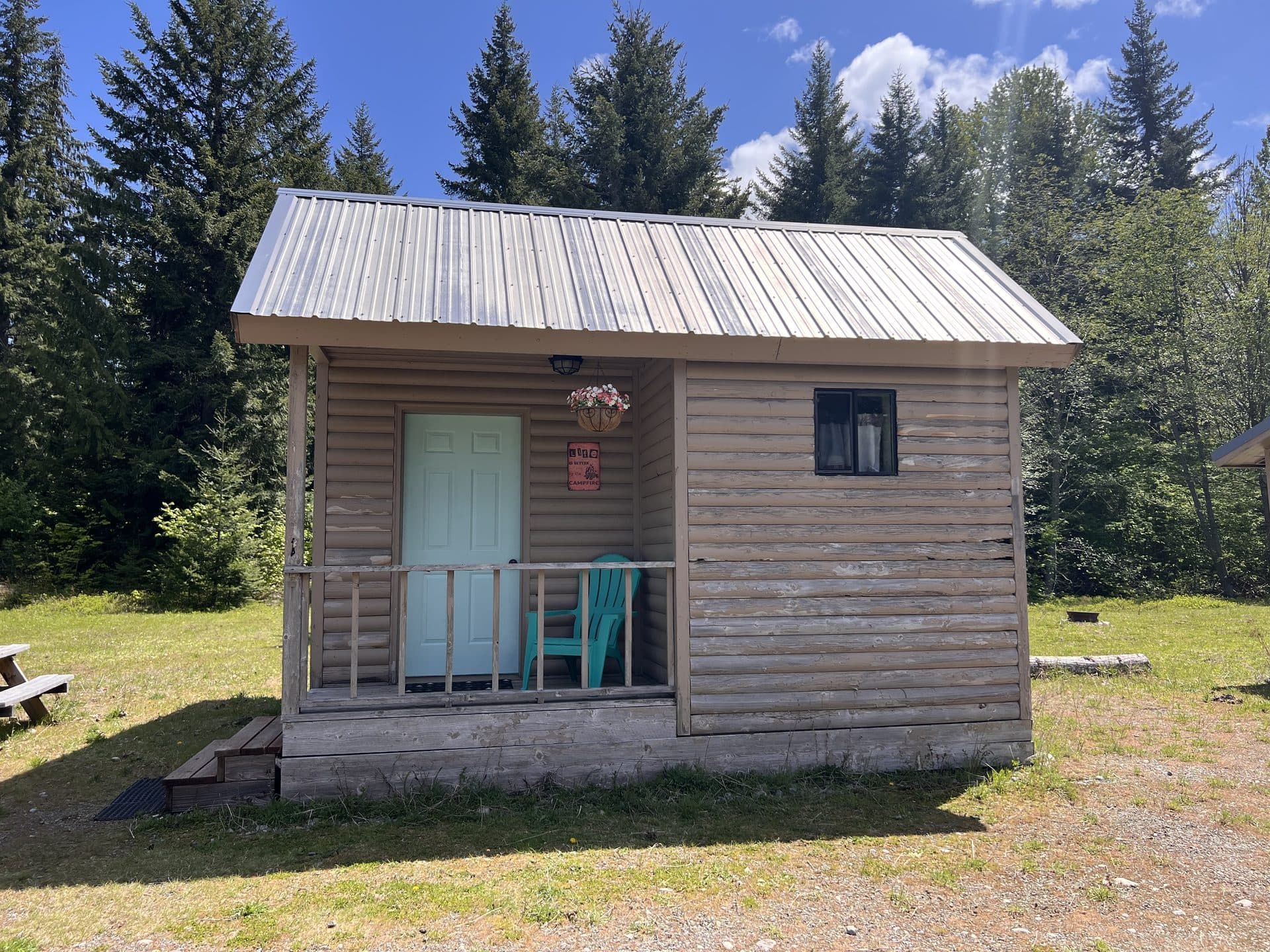 Rustic cabin surrounded by evergreen forest at Alpine Lakes Lodge