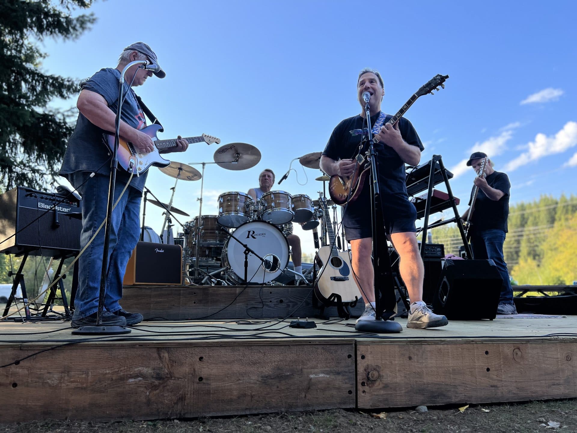 Live band performing on stage by the lake