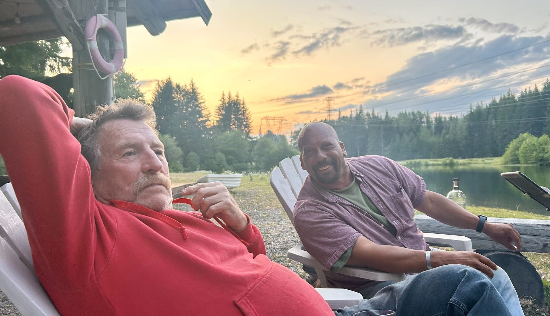 Guests relaxing lakeside at sunset