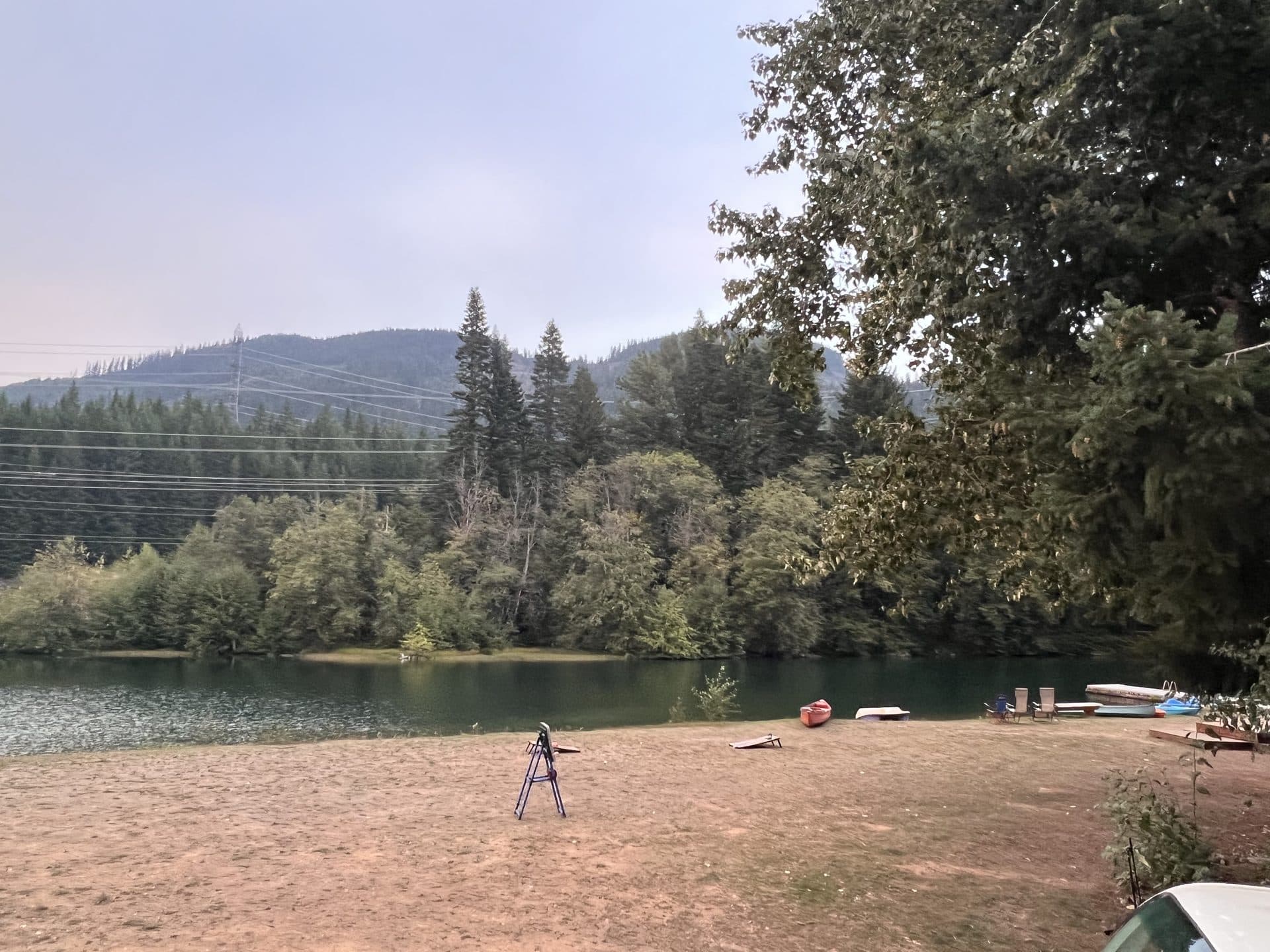 Private lake with kayaks on shore and mountain backdrop