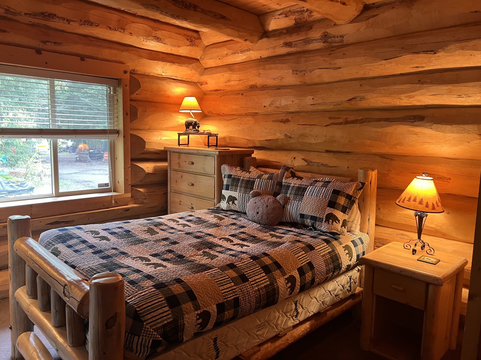 Lodge bedroom with warm lighting and log bed frame