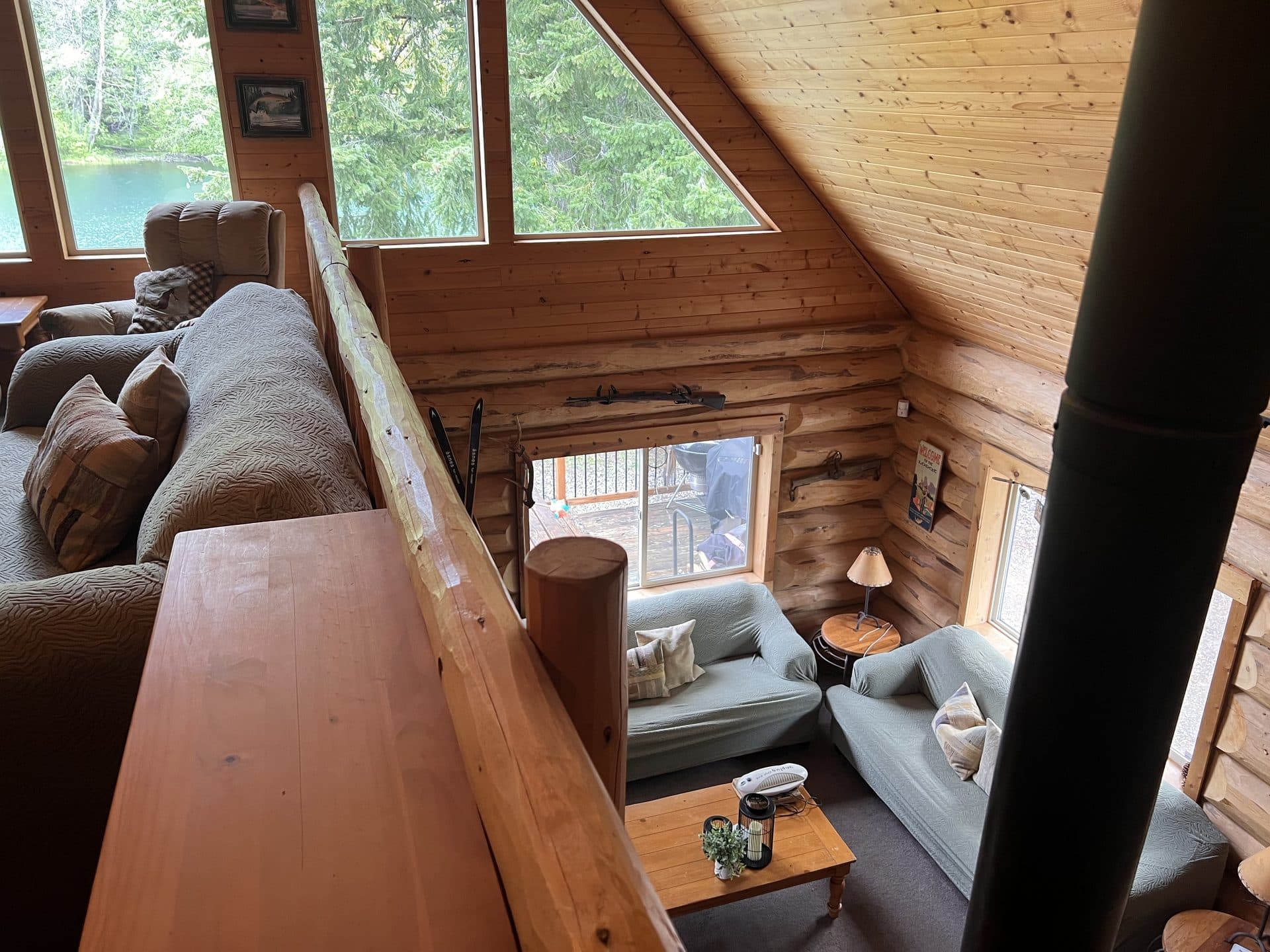 View from the lodge loft overlooking the living room and lake through windows