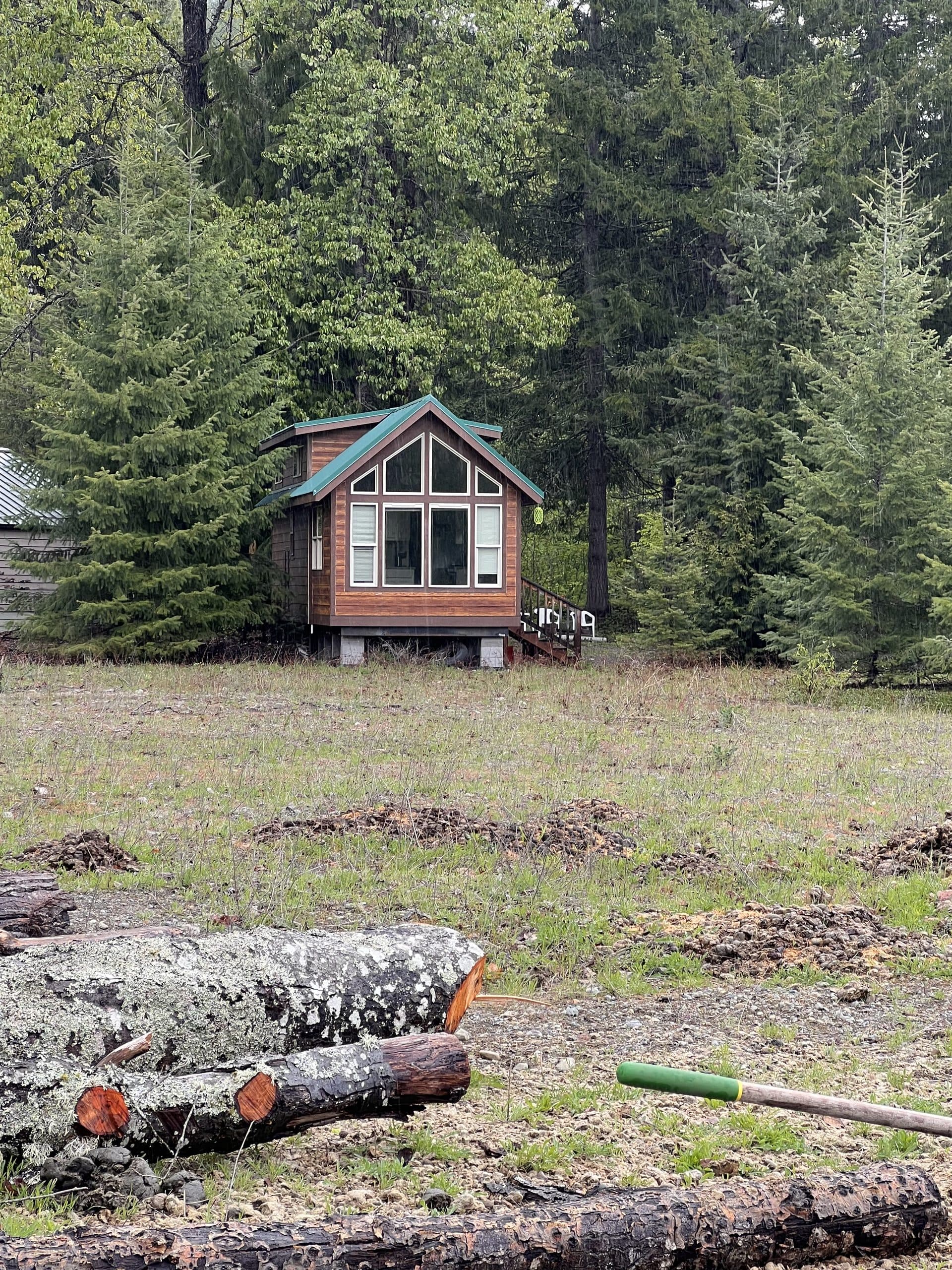 Tiny home A-frame exterior surrounded by forest
